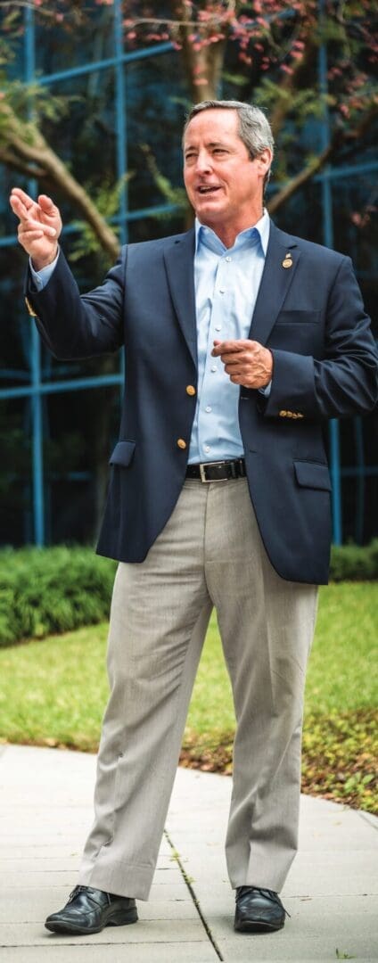 a man in a suit pointing his finger